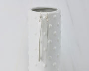 long silver bar earrings on dotted vase