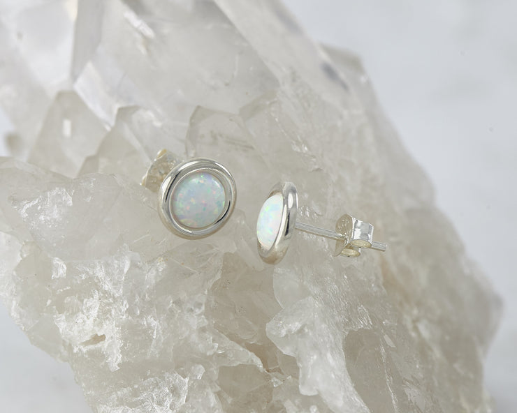 Silver opal earrings on crystal rock