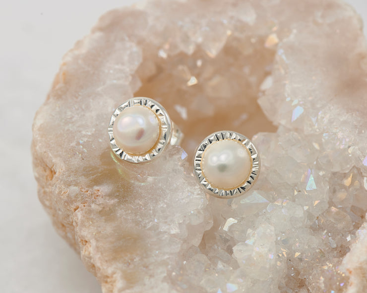 silver pearl stud earrings on quartz