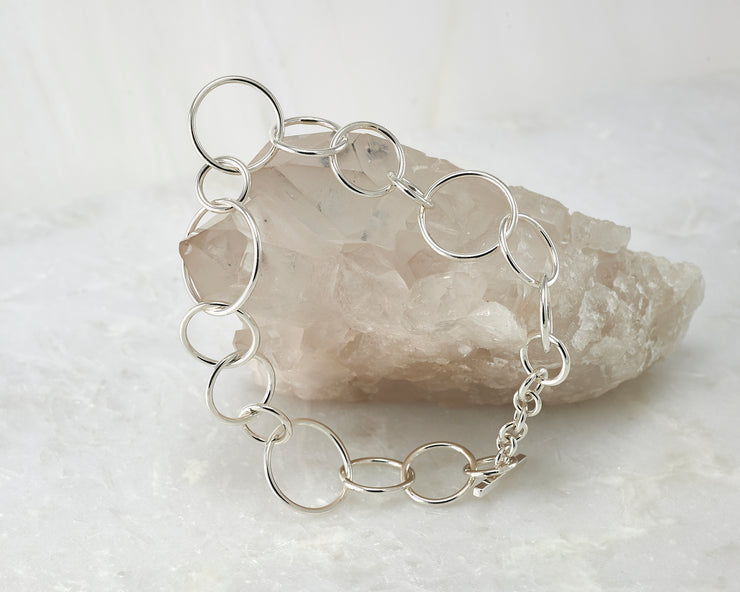 chain link latch bracelet shown closed on crystal rock