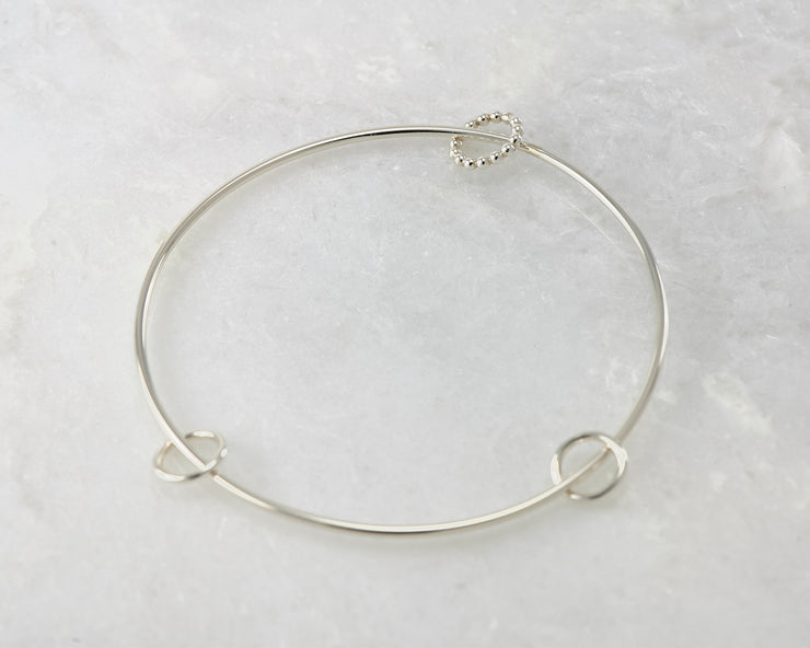bangle style charms silver bracelet on marble