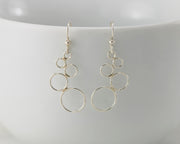 Silver circles chandelier earrings on white cup