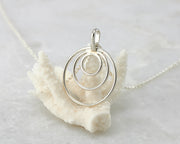 silver circles necklace on coral