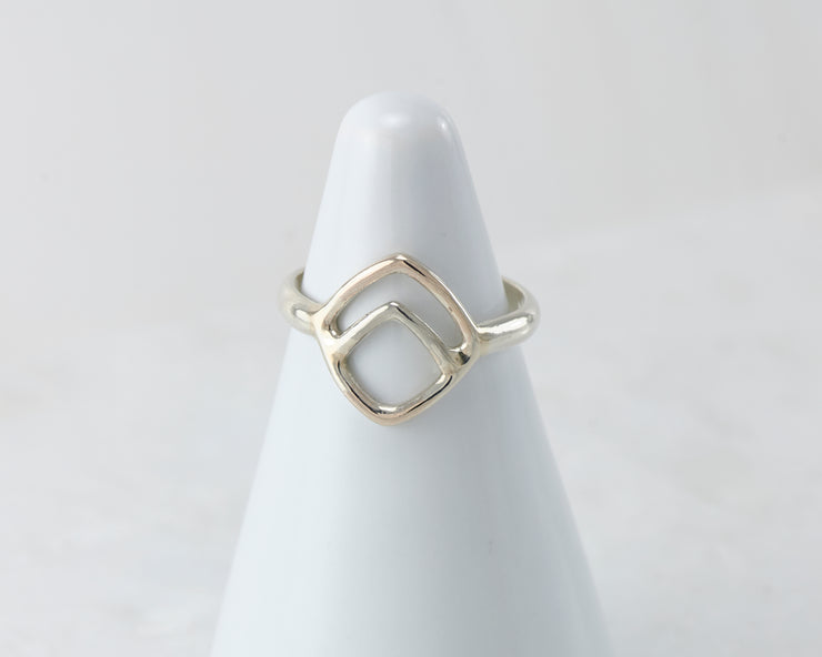 White ring holder with Geometric Silver ring