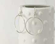 Silver medium hoop earrings on dotted vase