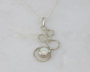 silver opal pendant on white marble