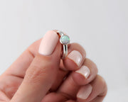woman holding opal ring