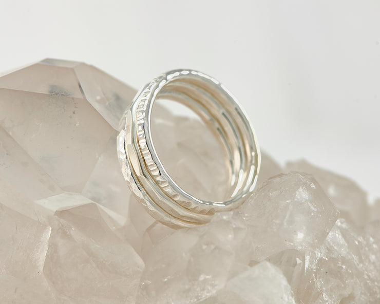 Silver hammered stacking rings on crystal rock