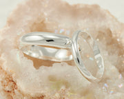 two silver wedding bands in crystal