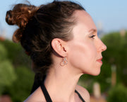 woman wearing silver small hoop earrings