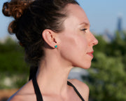 woman wearing silver turquoise stud earrings