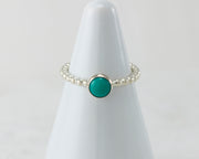 White ring holder with turquoise Silver ring