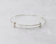 bangle bracelet silver adjustable open on marble