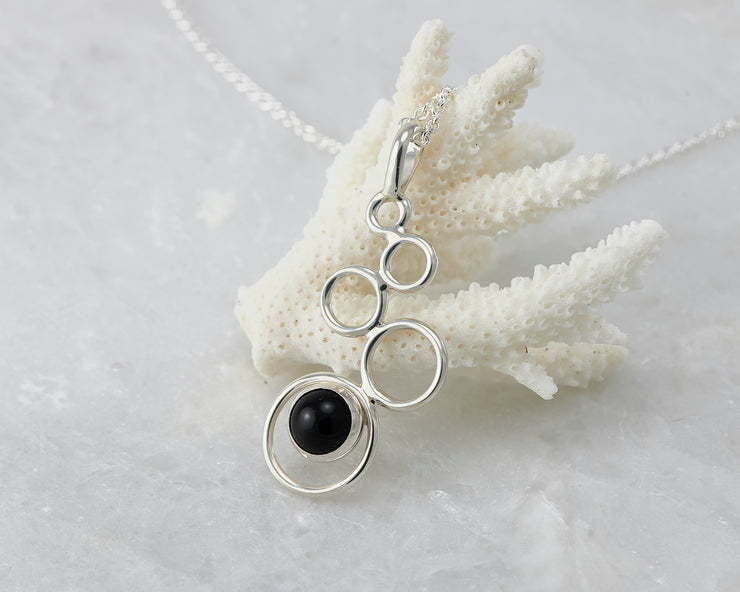 black onyx gemstone silver necklace on coral