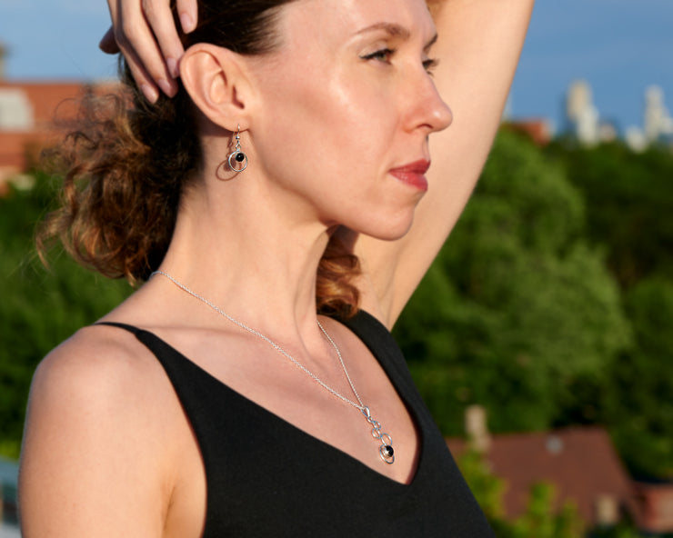 woman wearing black onyx necklace and matching black onyx earrings