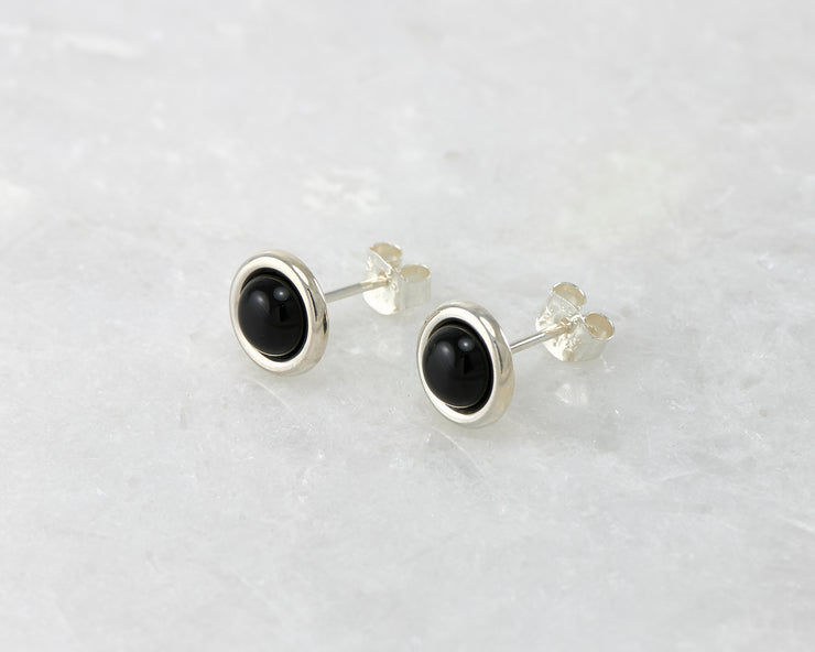 silver black onyx stud earrings on white marble