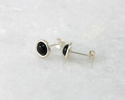 silver black onyx stud earrings on white marble
