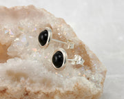 silver black onyx stud earrings on quartz