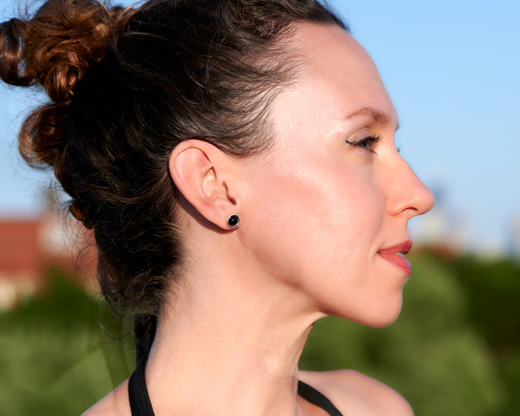 woman wearing silver black onyx stud earrings