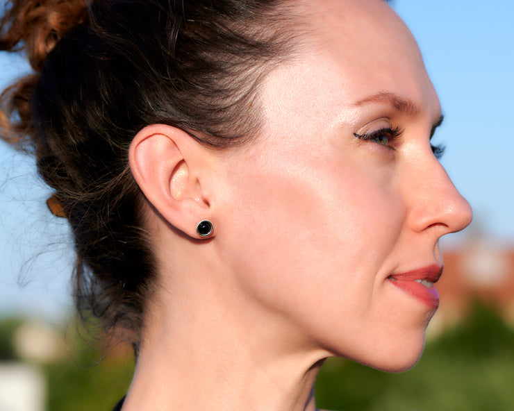 woman wearing silver black onyx stud earrings