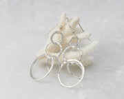 Silver hammered circles earrings on coral