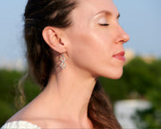 Woman wearing silver hammered squares earrings