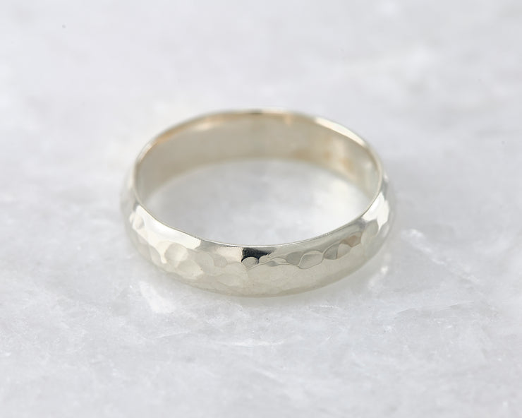 simple hammered ring on white marble