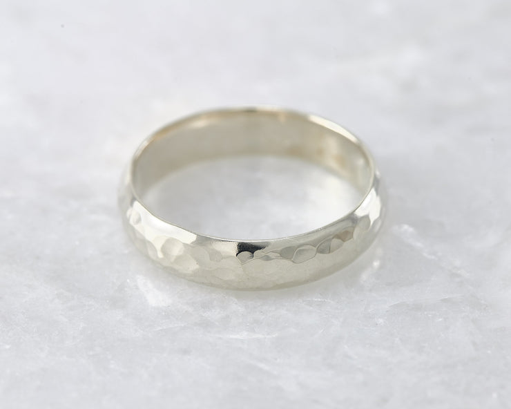 wedding ring laying on white marble