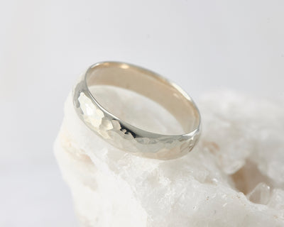 Silver hammered simple ring on white rock