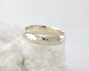 Silver hammered simple ring on white rock