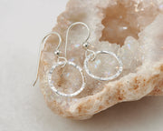 silver hammered hoop earrings on quartz