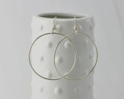silver large hoop earrings on dotted vase