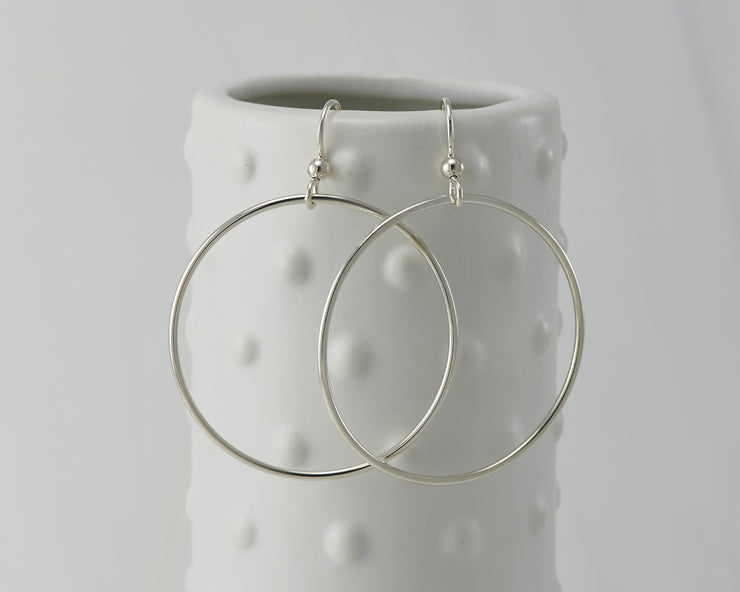 silver large hoop earrings on dotted vase