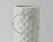silver large hoop earrings on geometric vase
