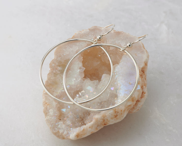 silver large hoop earrings on quartz