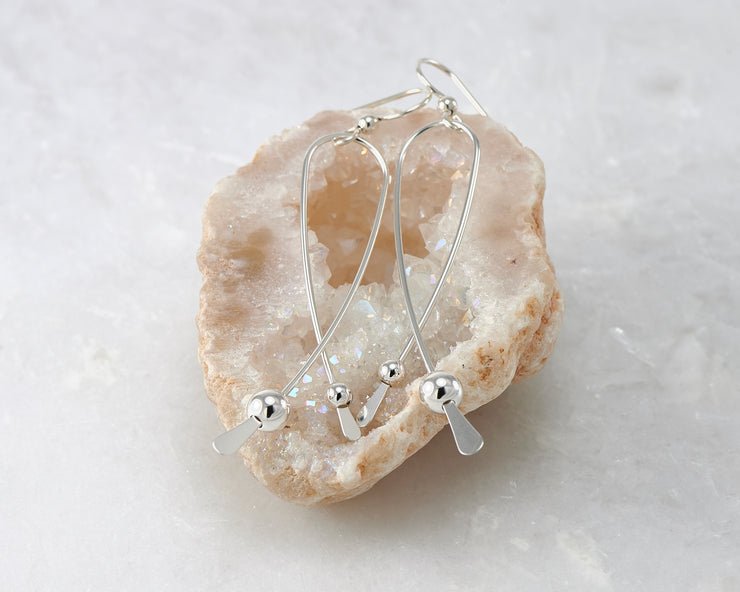 long curved silver earring in quartz