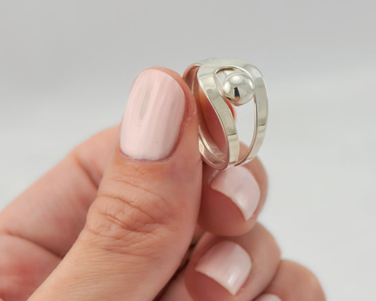 Woman holding silver wrap ring