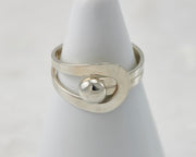 White ring holder with modern Silver ring