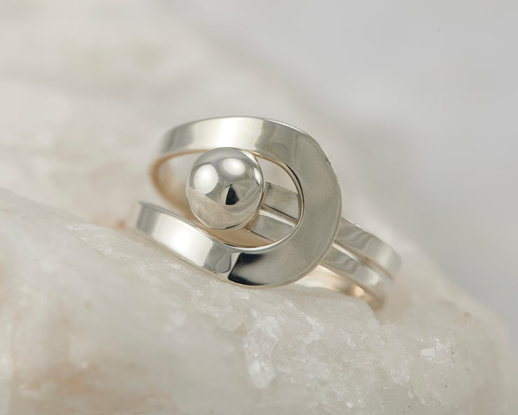 Silver modern wrap ring on white rock
