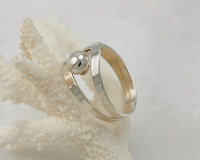 Silver modern ring on coral