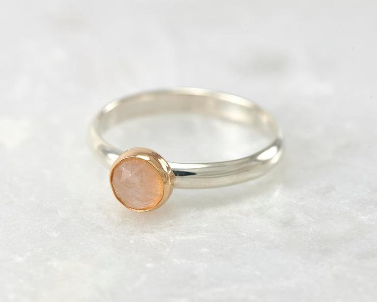 moonstone engagement silver and gold ring on white marble