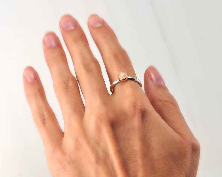 woman wearing moonstone engagement silver and gold ring