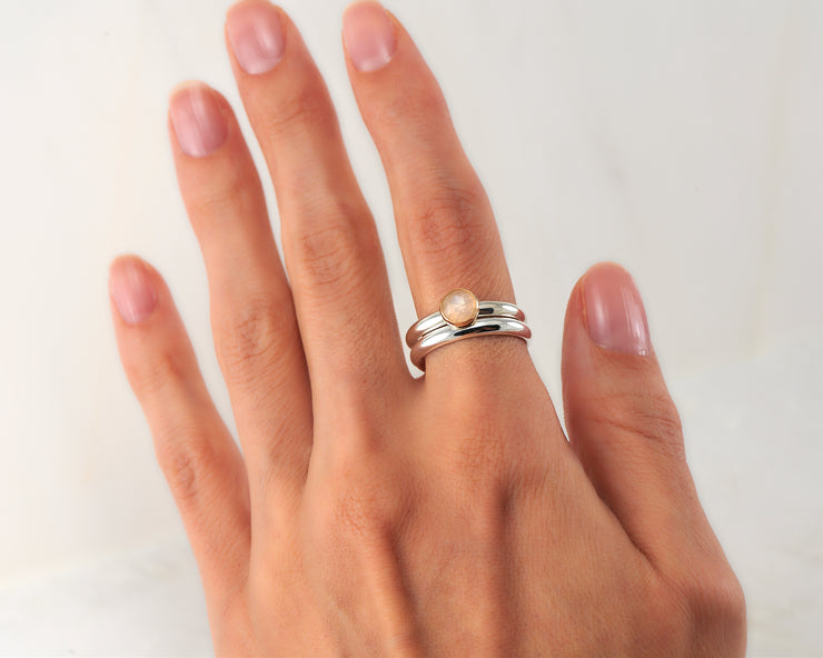woman wearing moonstone engagement ring & matching wedding ring
