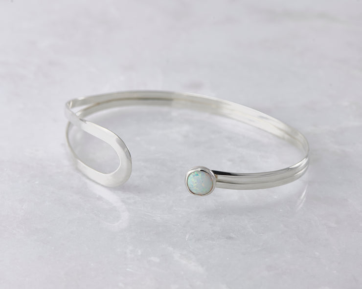 latch style opal silver bracelet open on marble