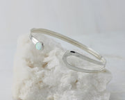 latch silver opal bracelet open on white rock