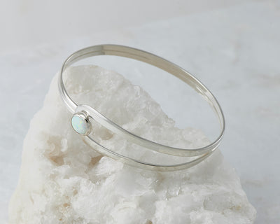 Silver Opal Bracelet on white rock