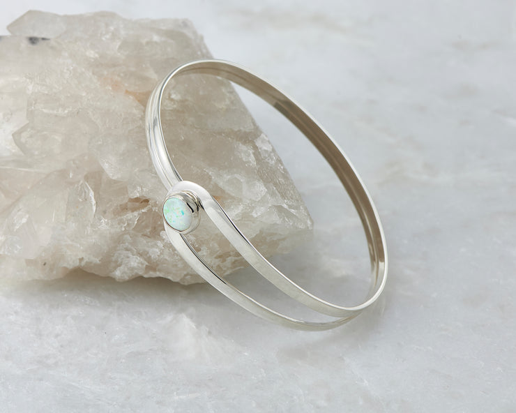 opal latch bracelet shown closed on crystal rock