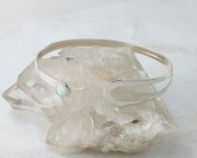 opal latch bracelet shown open on crystal rock