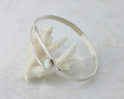 silver latch opal bracelet balanced on coral