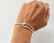 Woman wearing silver opal latch bracelet